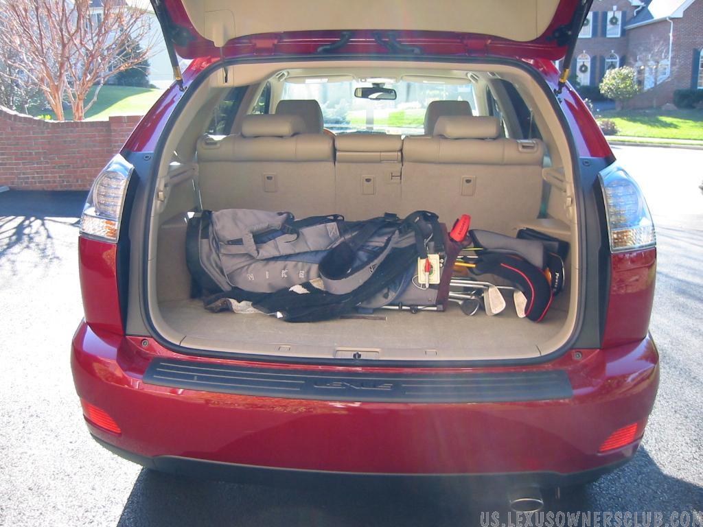 Golf clubs fit straight across, nice wide car!
